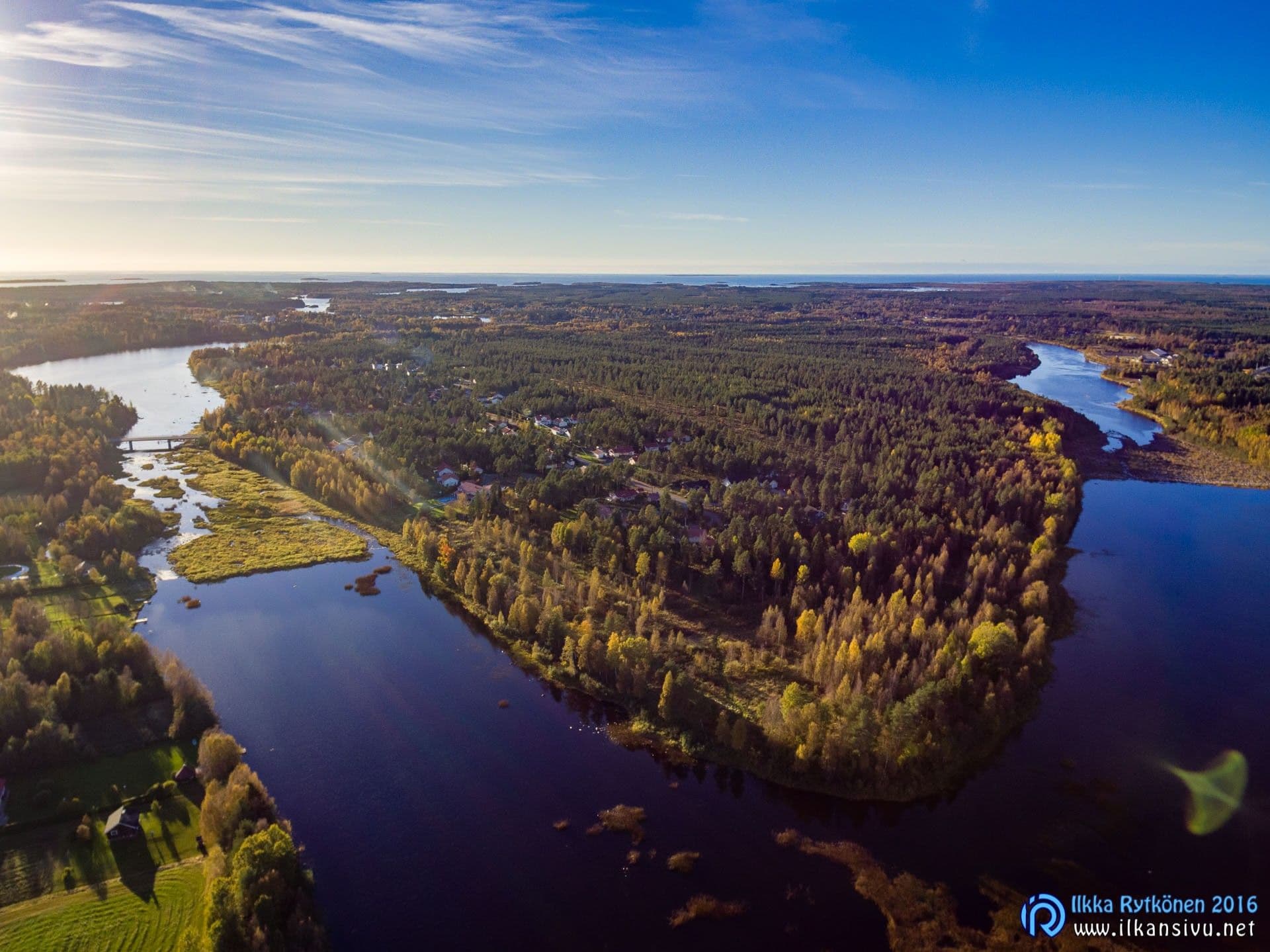 Aerial view of a wooded peninsula with water on either side