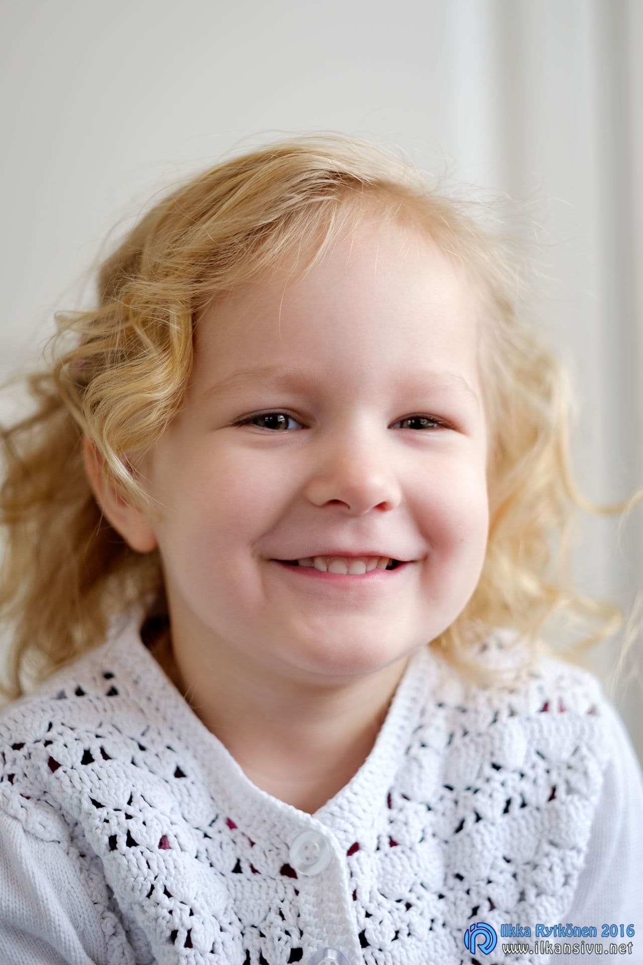 Close-up portrait of a smiling fair-haired child