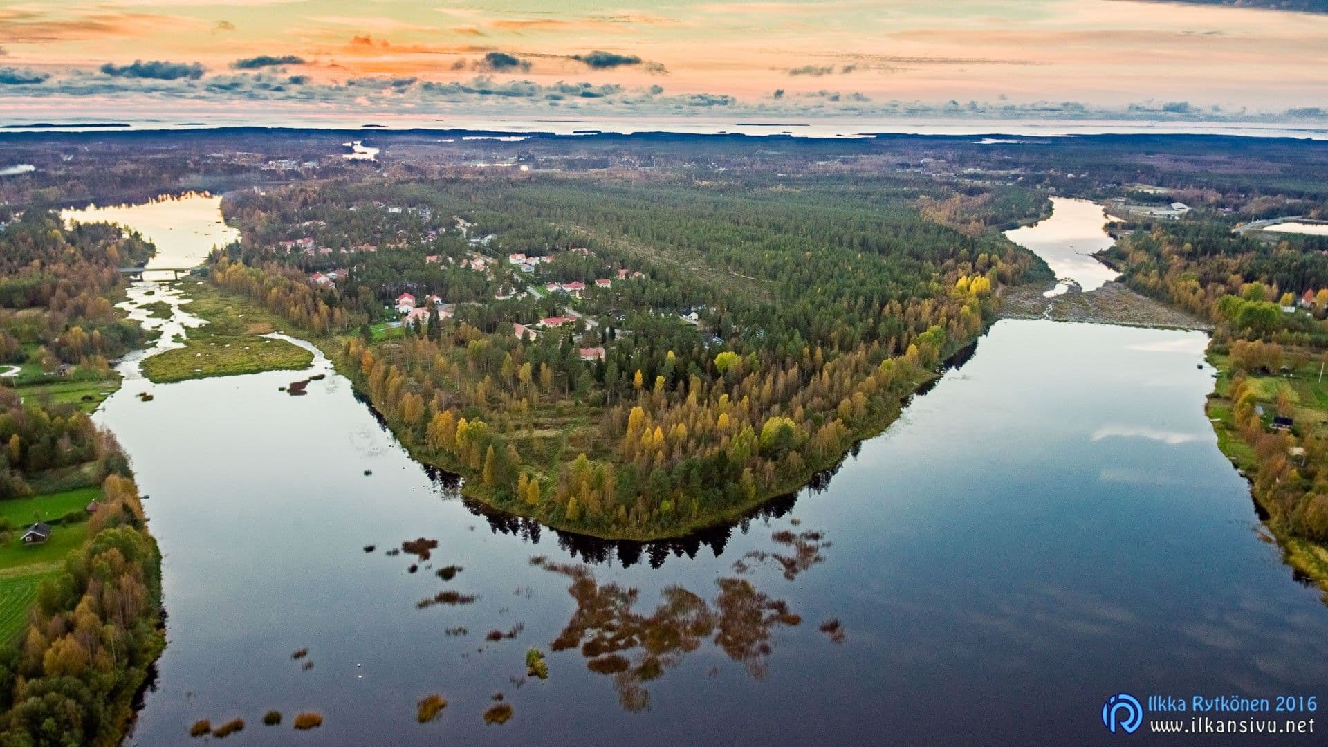 Aerial view of a wooded river bend in the evening light